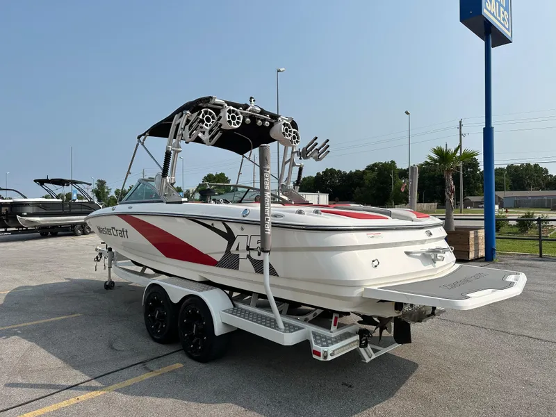 Slide: The Image of 2012 MasterCraft X45 boat on trailer in parking lot, ready for water sports. - 6