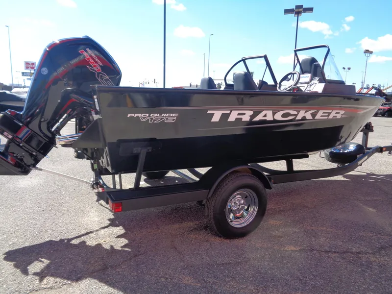 Slide: The Image of 2025 Tracker Pro Guide V-175 WT boat on trailer, parked outdoors. - 4