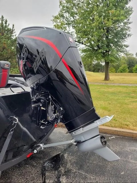 Slide: The Image of 2024 Ranger VX1888 WT boat with powerful outboard motor in a park setting. - 2