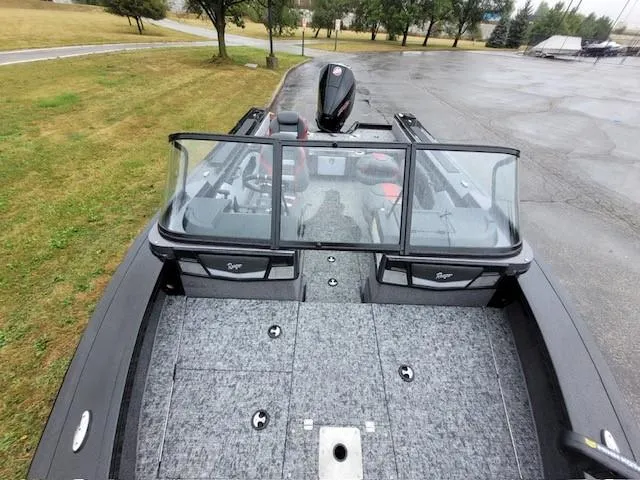 Slide: The Image of 2024 Ranger VX1888 WT boat with spacious deck and windshield, parked on a wet surface. - 5