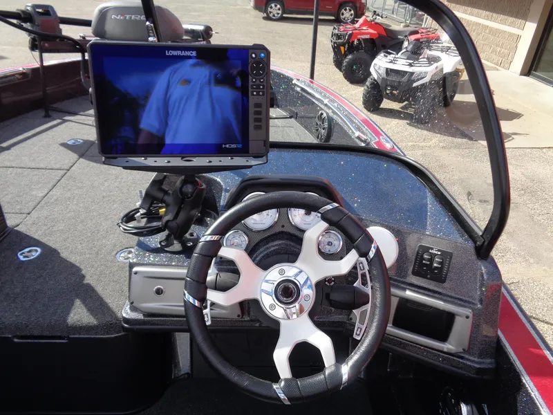 Slide: The Image of 2024 Nitro ZV20 Pro boat dashboard with steering wheel and navigation display. - 13