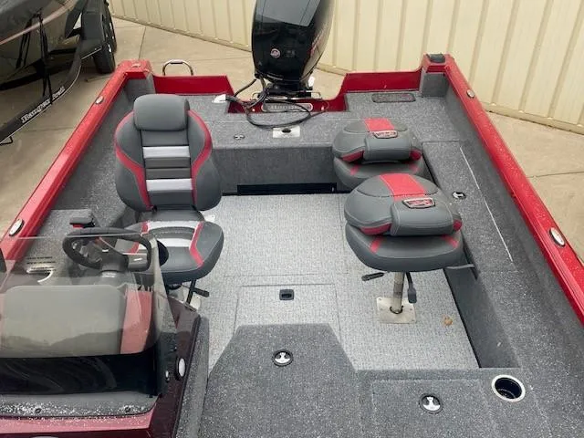 The Image of 2024 Ranger VS1782SC Angler boat in red on a trailer, parked outdoors. - 0