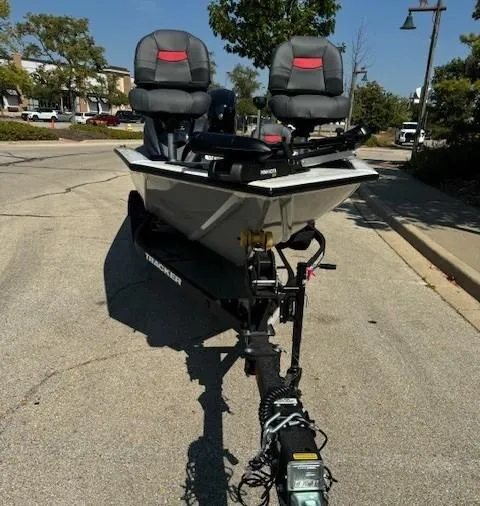 Slide: The Image of 2025 Tracker Pro Team 175 Crappie Edition boat parked on a sunny street. - 2