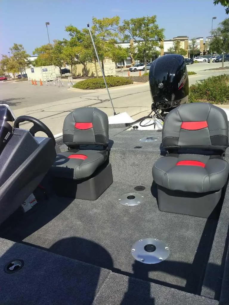 Slide: The Image of 2025 Tracker Pro Team 175 Crappie Edition boat with dual seats and motor in parking lot. - 6
