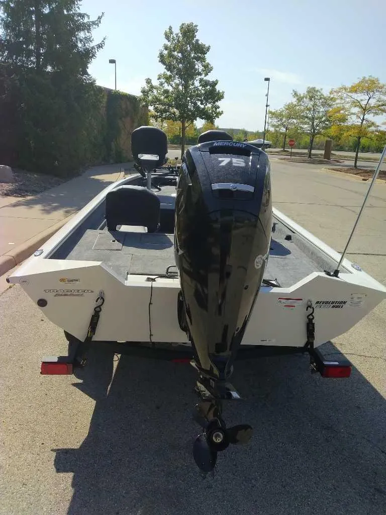 Slide: The Image of 2025 Tracker Pro Team 175 Crappie Edition boat with 75 HP motor, parked outdoors. - 8