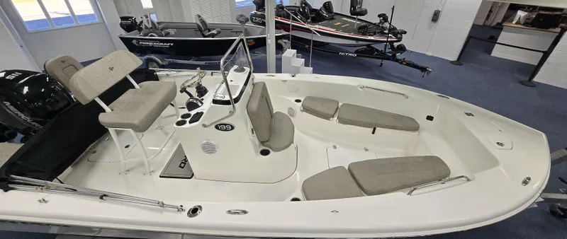 Slide: The Image of 2022 Sea Pro 199 Center Console boat with seating, displayed indoors. - 3