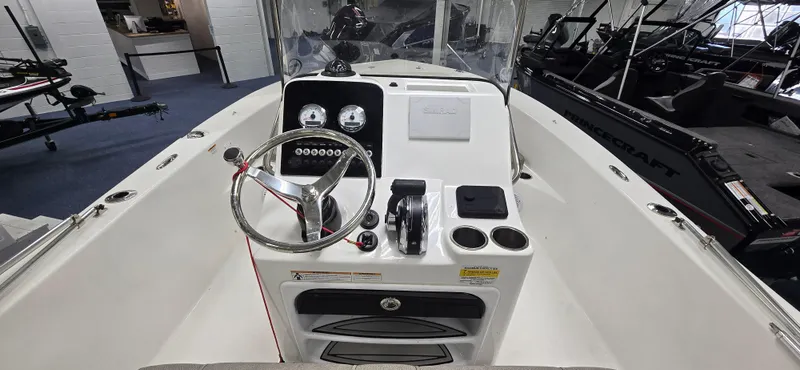 Slide: The Image of 2022 Sea Pro 199 Center Console boat interior with steering wheel and controls. - 6