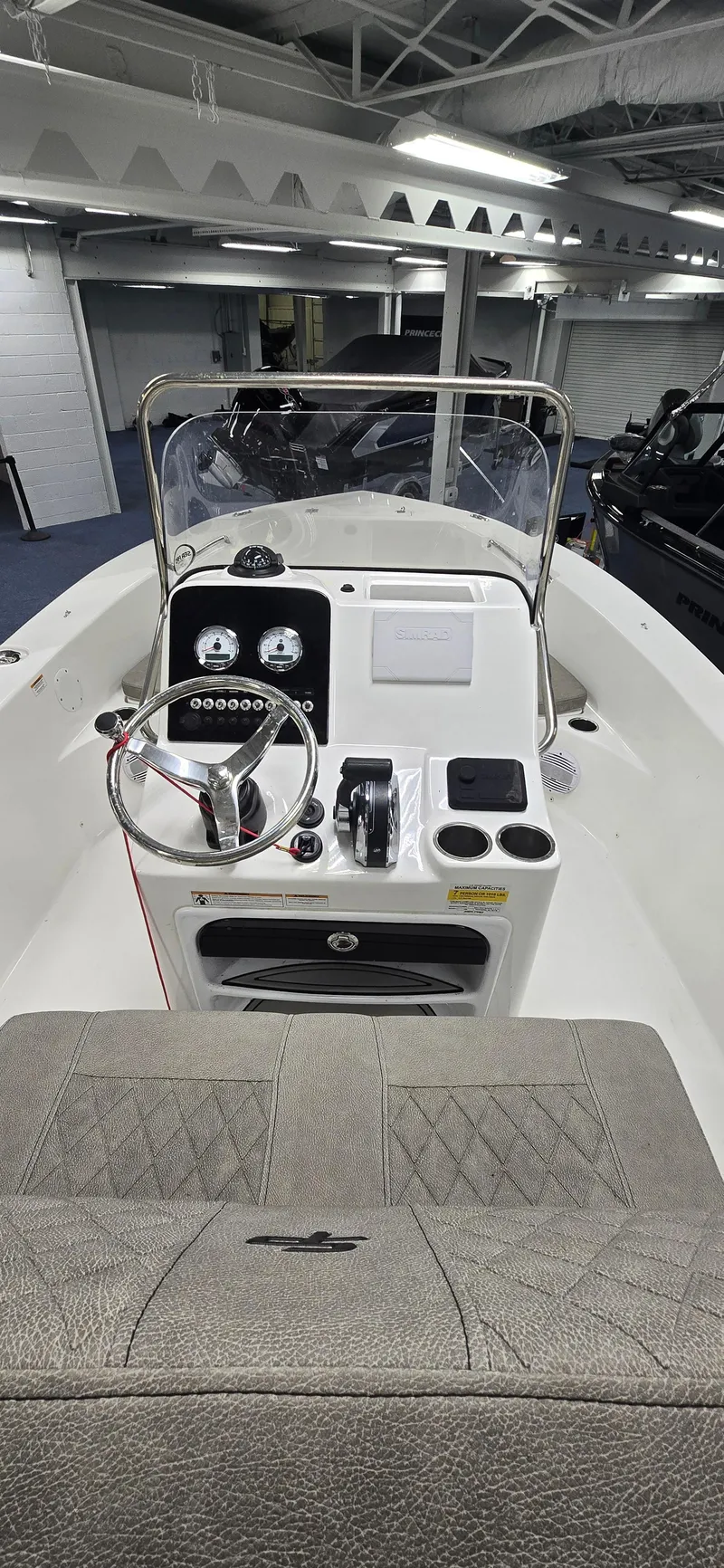 Slide: The Image of 2022 Sea Pro 199 Center Console boat interior with steering wheel and dashboard controls. - 8