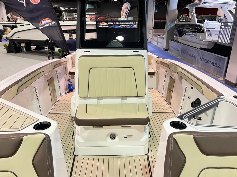 Slide: The Image of 2025 Yamaha Boats 255 FSH Sport H interior with beige seating and sleek design. - 10