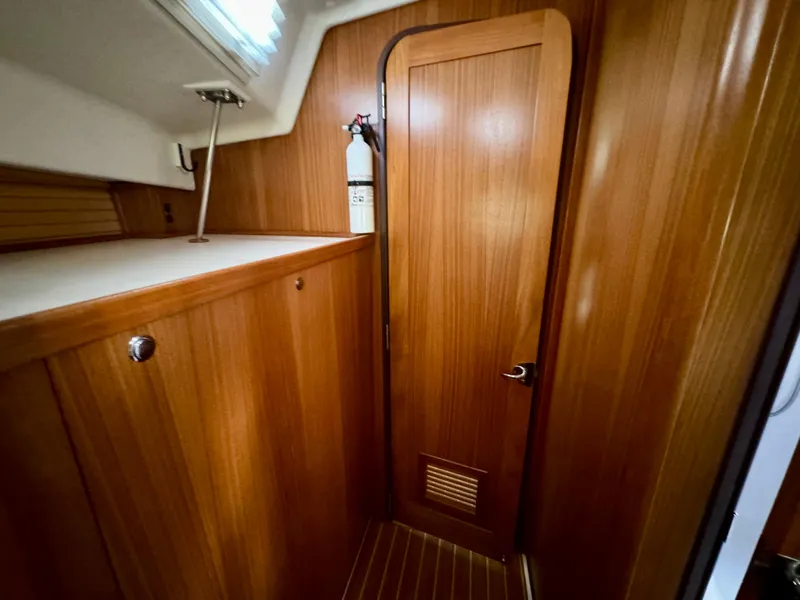 Slide: The Image of Interior of 2018 Catalina 425 sailboat with wooden cabinetry and fire extinguisher. - 49