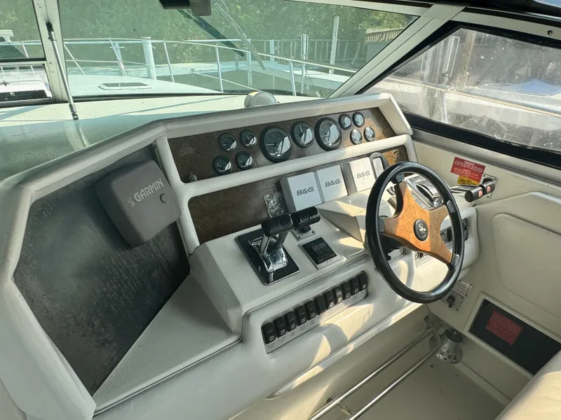Slide: The Image of 1995 Sea Ray 370 Express Cruiser helm with gauges, controls, and steering wheel. - 10