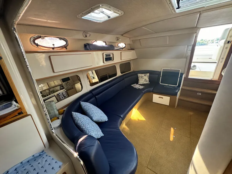 Slide: The Image of Interior of 1995 Sea Ray 370 Express Cruiser with blue seating and nautical decor. - 20