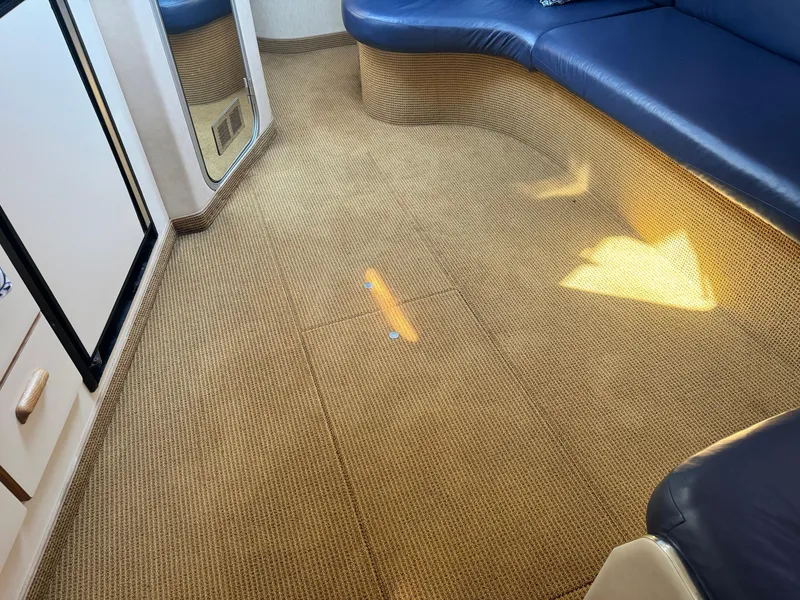 Slide: The Image of Interior of 1995 Sea Ray 370 Express Cruiser with carpet and blue seating. - 23