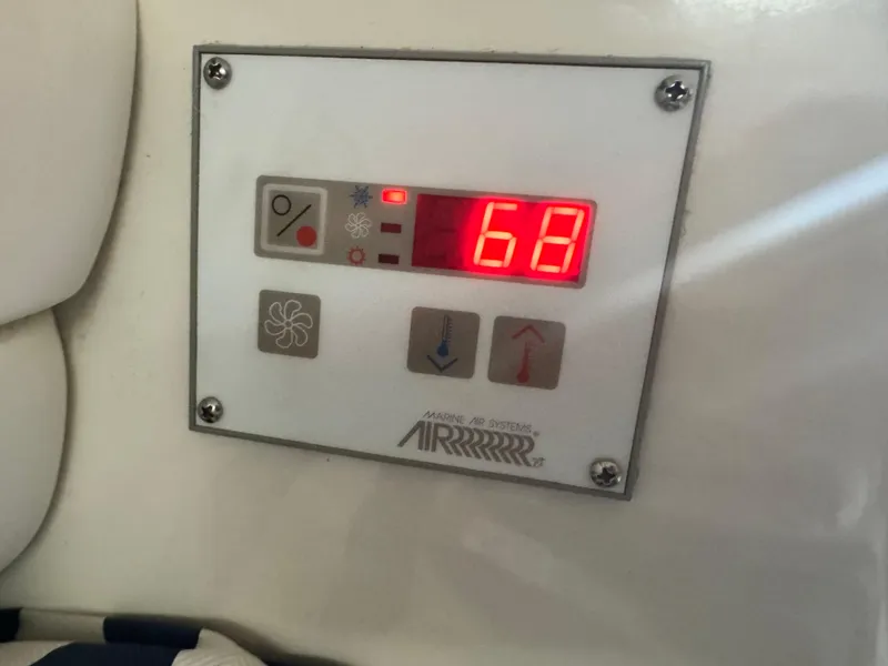 Slide: The Image of Digital control panel on 1995 Sea Ray 370 Express Cruiser displaying temperature at 68 degrees. - 28