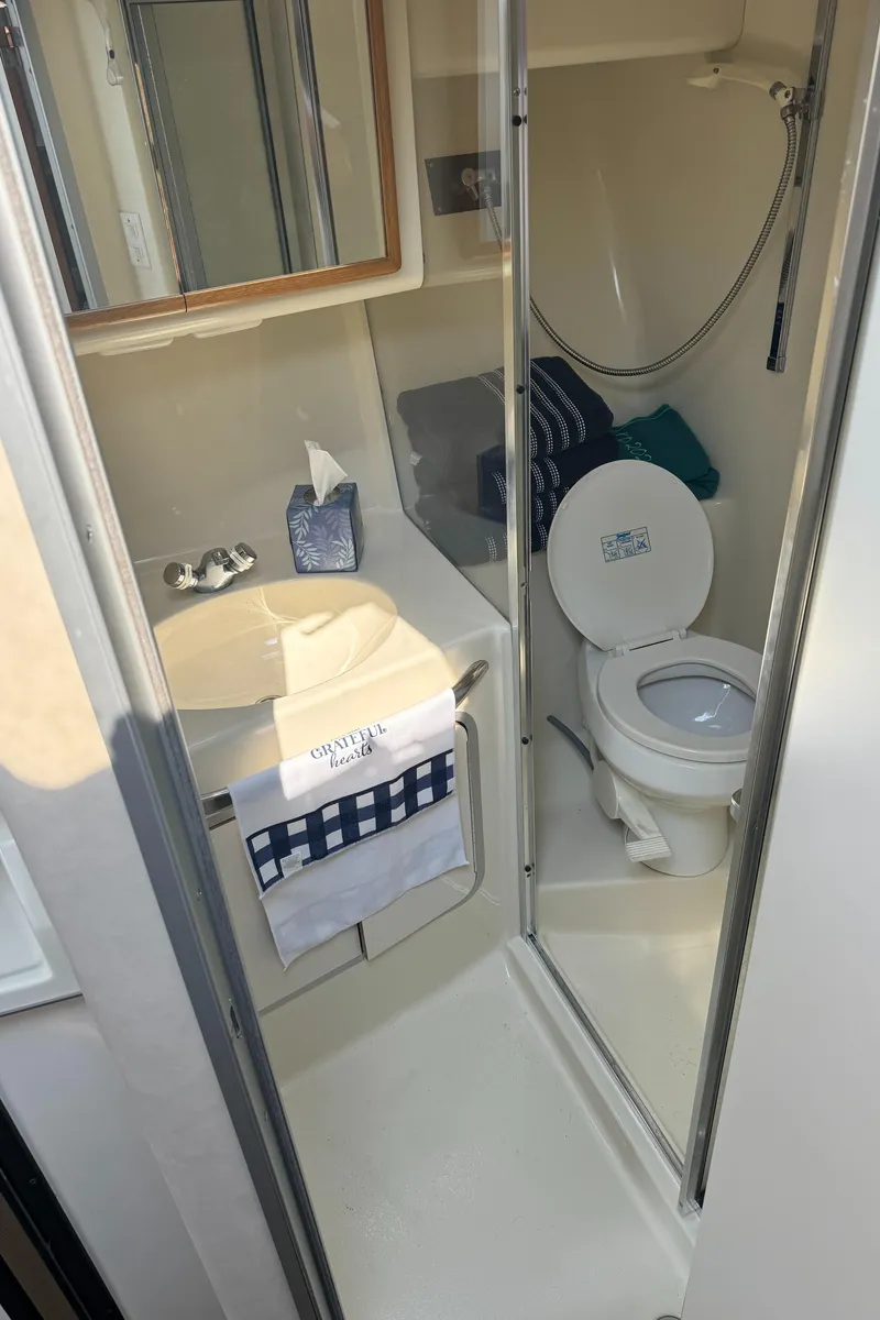 Slide: The Image of Bathroom interior of 1995 Sea Ray 370 Express Cruiser with toilet and sink. - 30