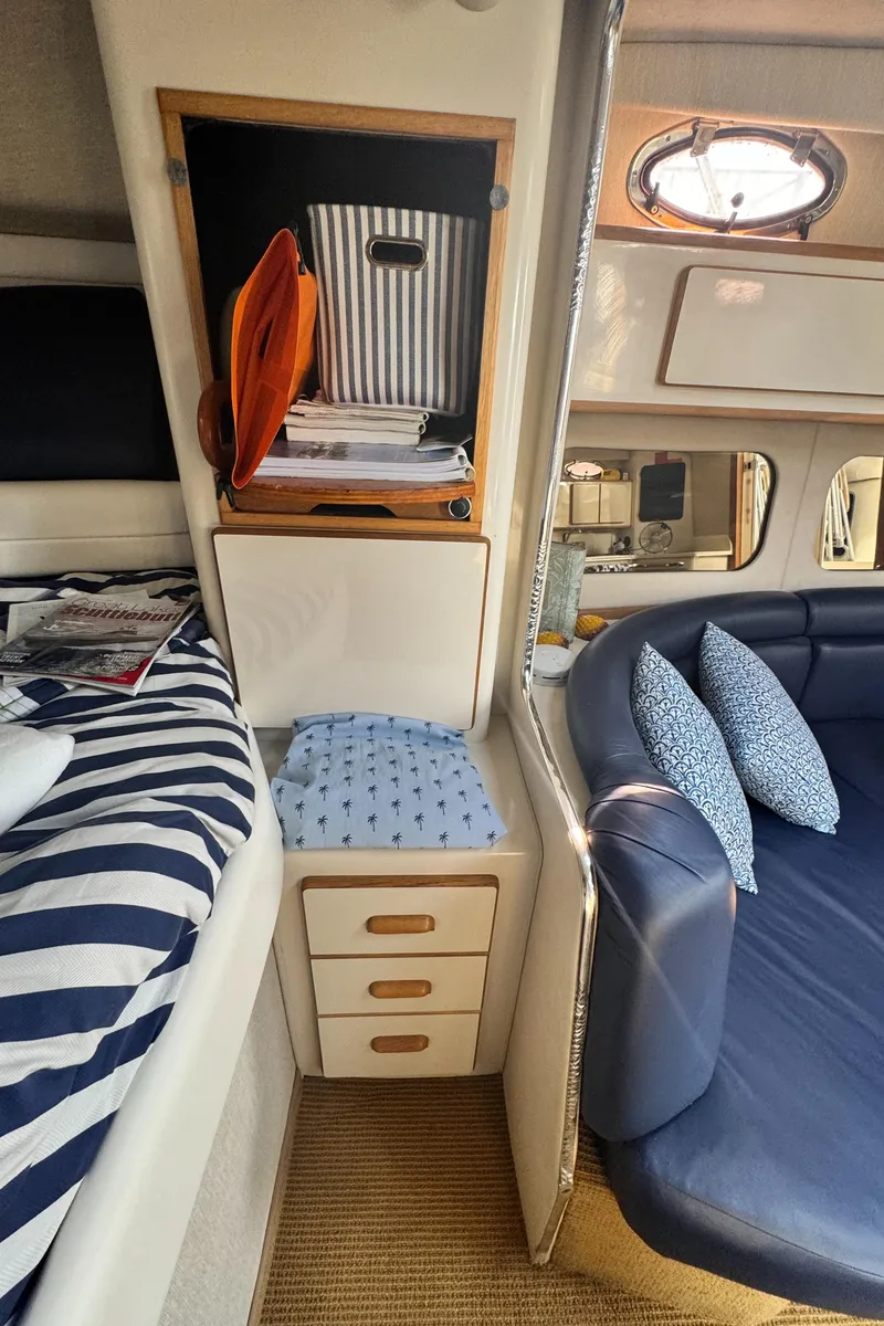Slide: The Image of Interior of 1995 Sea Ray 370 Express Cruiser with cozy seating and storage. - 32