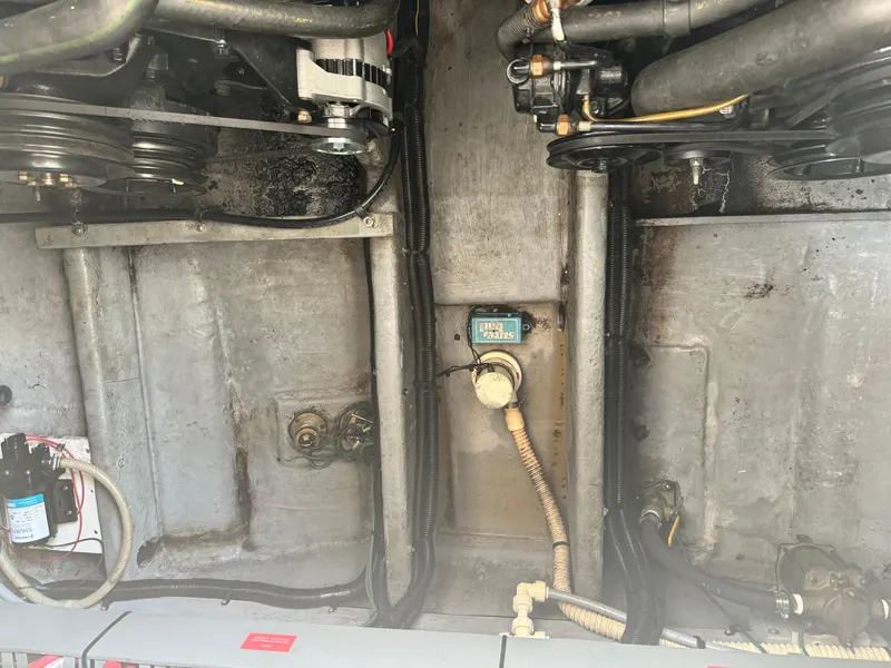 Slide: The Image of Engine compartment of a 1995 Sea Ray 370 Express Cruiser, showing mechanical components and wiring. - 37