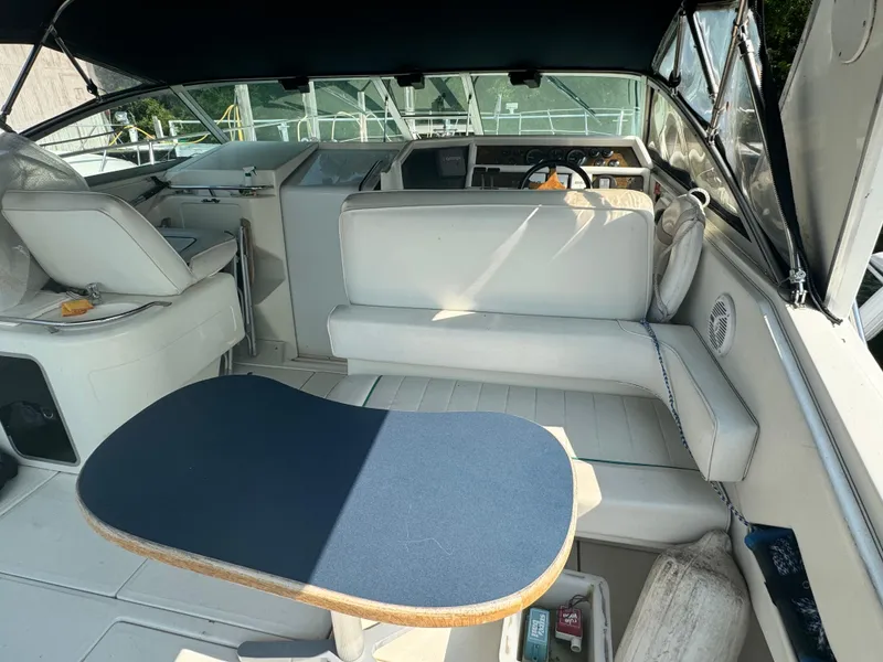 Slide: The Image of 1995 Sea Ray 370 Express Cruiser interior with seating and table. - 9