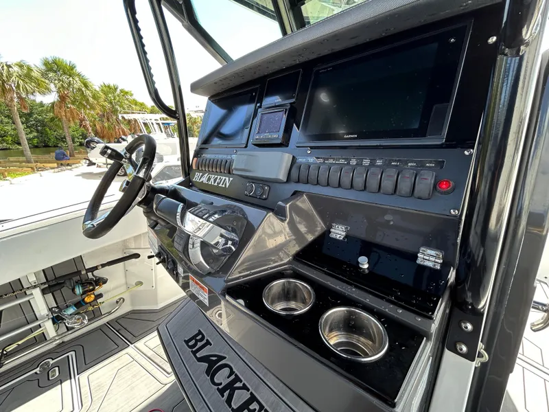 Slide: The Image of 2019 Blackfin 272 CC boat dashboard with steering wheel and electronic controls. - 13
