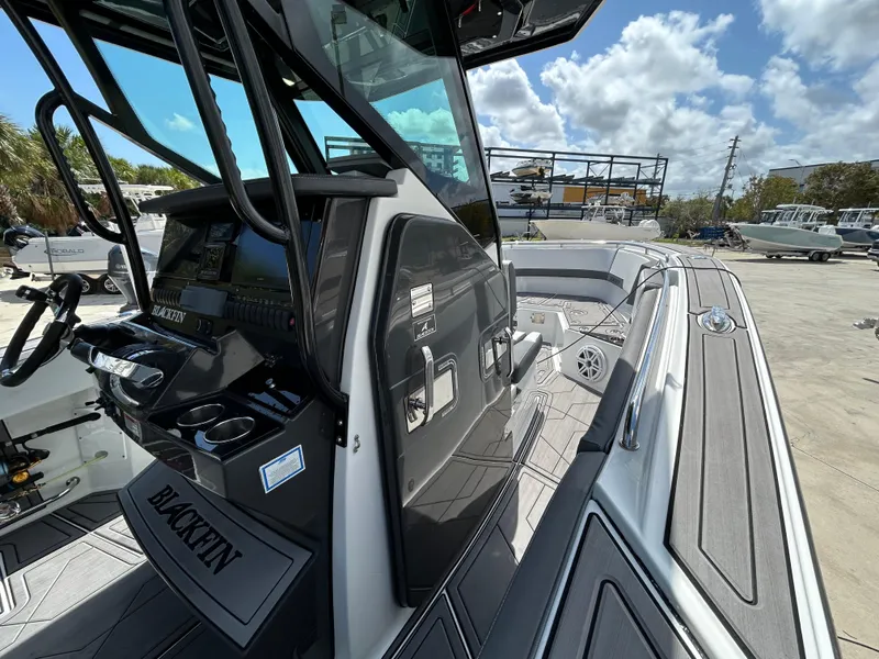 Slide: The Image of 2019 Blackfin 272 CC boat interior with modern console and seating. - 15