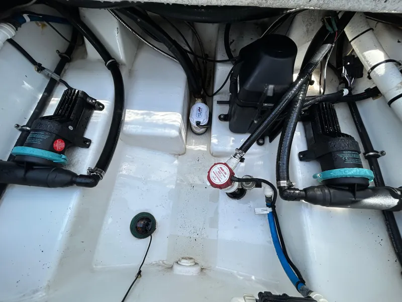 Slide: The Image of 2019 Blackfin 272 CC boat engine compartment with pumps and wiring. - 25