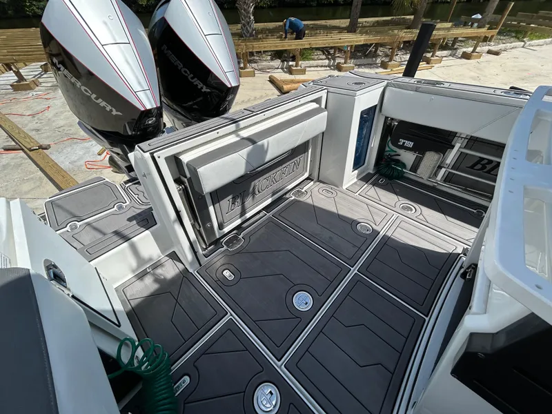 Slide: The Image of 2019 Blackfin 272 CC boat deck with dual Mercury engines and sleek design. - 8