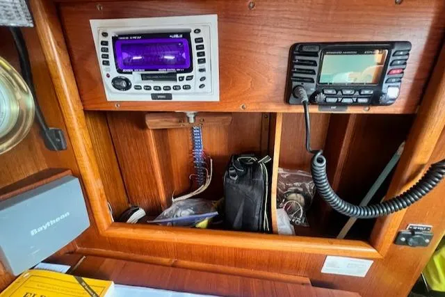 Slide: The Image of Wooden boat dashboard with navigation equipment, featuring Robinhood Cutter 1999 model. - 13