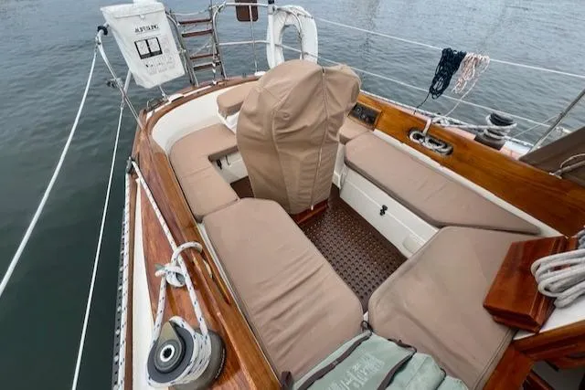 Slide: The Image of 1999 Robinhood Cutter sailboat cockpit with cushioned seating and wooden accents. - 30