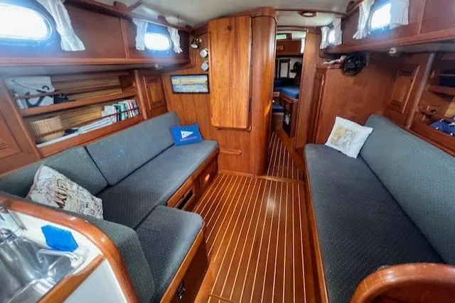 Slide: The Image of Cozy 1999 Robinhood Cutter yacht interior with wooden finish and comfortable seating. - 4