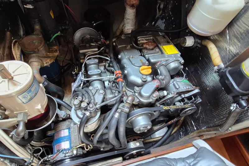 Slide: The Image of Engine compartment of a 1999 Robinhood Cutter sailboat, showcasing mechanical components and wiring. - 41
