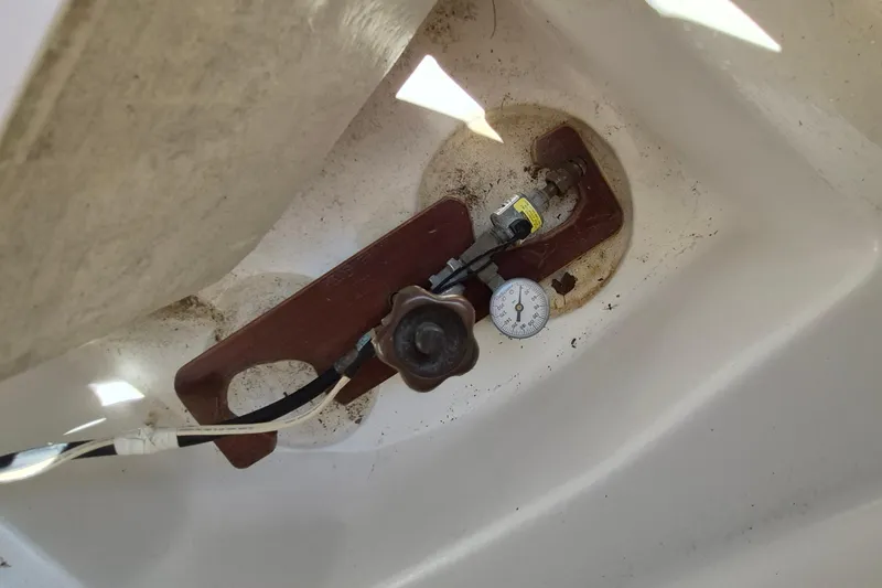 Slide: The Image of Control panel of a 1999 Robinhood Cutter with gauge and valve in a white compartment. - 55