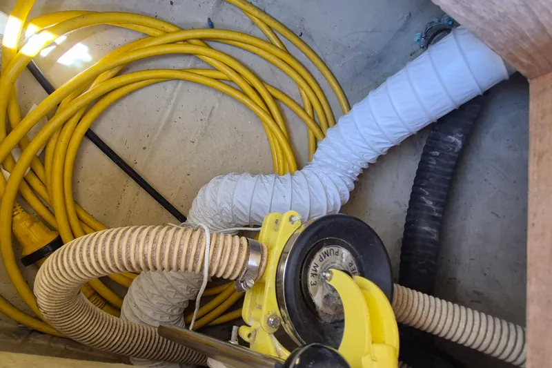Slide: The Image of Tangled hoses and cables in a Robinhood Cutter 1999 boat compartment. - 56