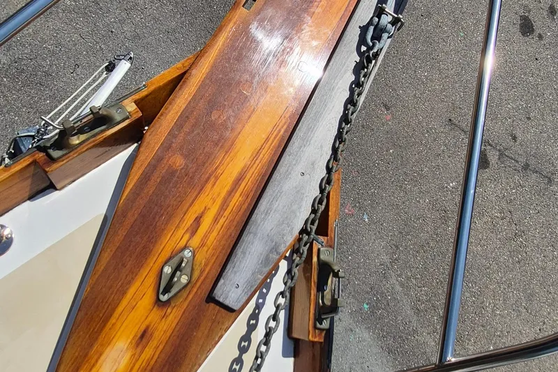 Slide: The Image of Close-up of 1999 Robinhood Cutter boat deck with polished wood and metal chain. - 57
