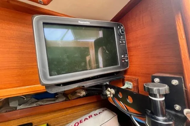 Slide: The Image of Raymarine navigation display on 1999 Robinhood Cutter sailboat, mounted on wooden interior. - 16