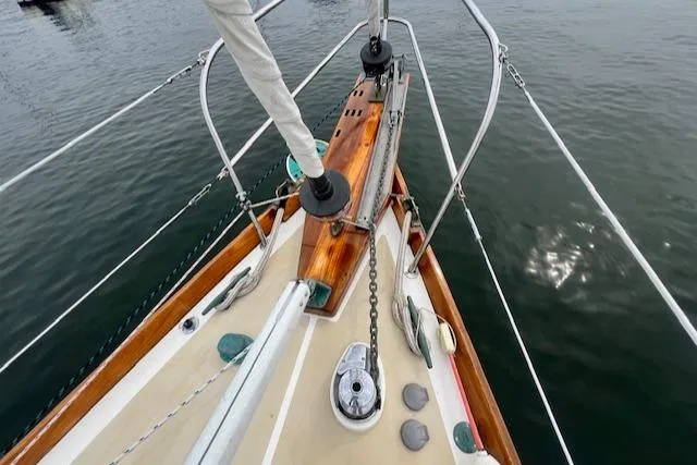 Slide: The Image of Bow of 1999 Robinhood Cutter sailboat with wooden deck and metal fittings. - 27