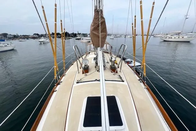 Slide: The Image of Sailboat deck view of 1999 Robinhood Cutter in a calm harbor setting. - 28