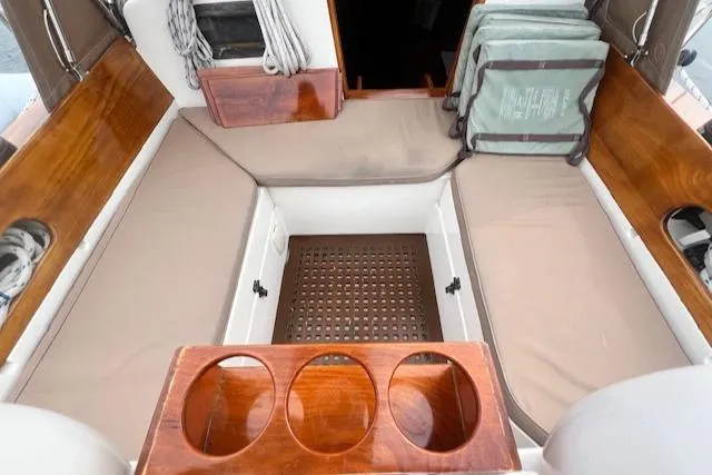 Slide: The Image of 1999 Robinhood Cutter boat interior with wooden seating and cup holders. - 32