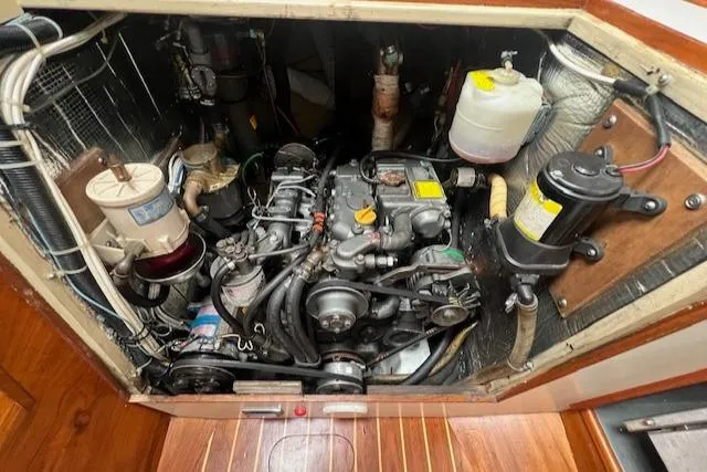 Slide: The Image of Engine compartment of a 1999 Robinhood Cutter sailboat, showcasing detailed mechanical components. - 44
