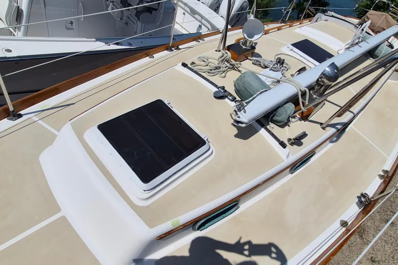 Slide: The Image of Deck of 1999 Robinhood Cutter sailboat with hatches and rigging details. - 53