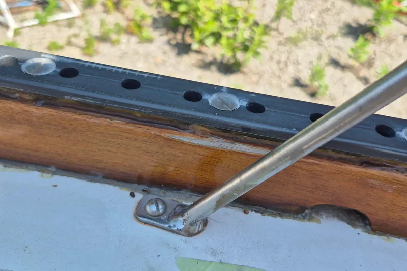 Slide: The Image of Close-up of a 1999 Robinhood Cutter sailboat's deck hardware and railing. - 59