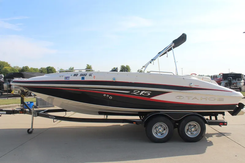 Slide: The Image of 2015 Tahoe 215 I/O boat on trailer, side view, outdoors. - 12