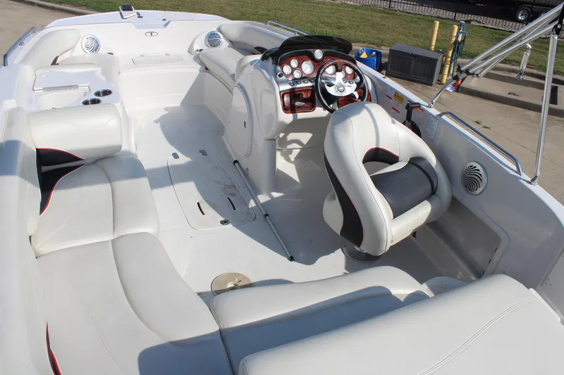 Slide: The Image of 2015 Tahoe 215 I/O boat interior with white seating and modern dashboard. - 14