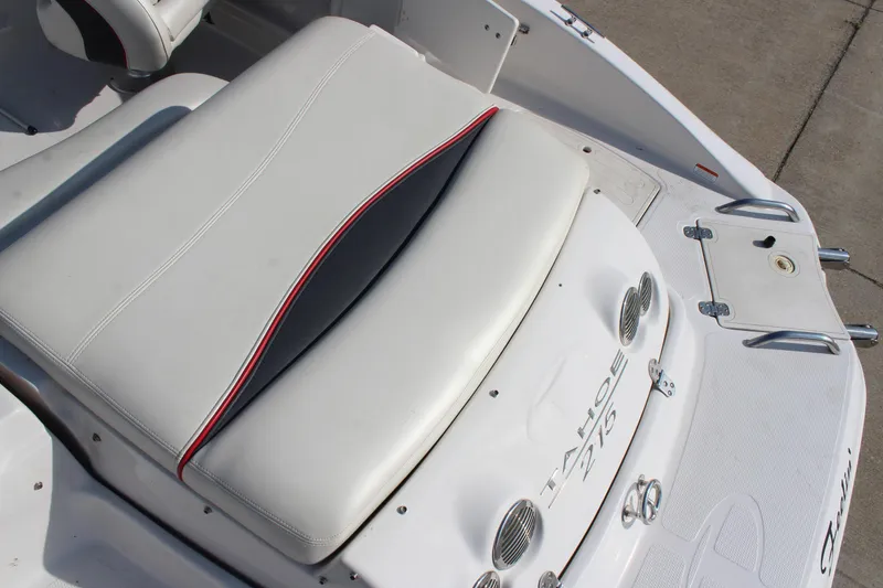 Slide: The Image of 2015 Tahoe 215 I/O boat interior with white seating and red accents. - 15
