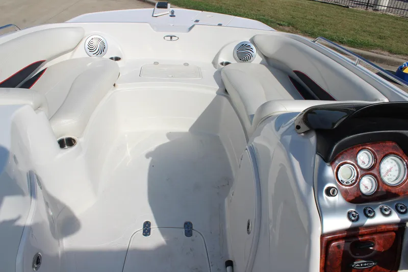 Slide: The Image of 2015 Tahoe 215 I/O boat interior with white seating and dashboard controls. - 17