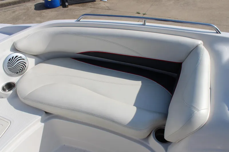 Slide: The Image of 2015 Tahoe 215 I/O boat interior with white cushioned seating and speaker. - 20