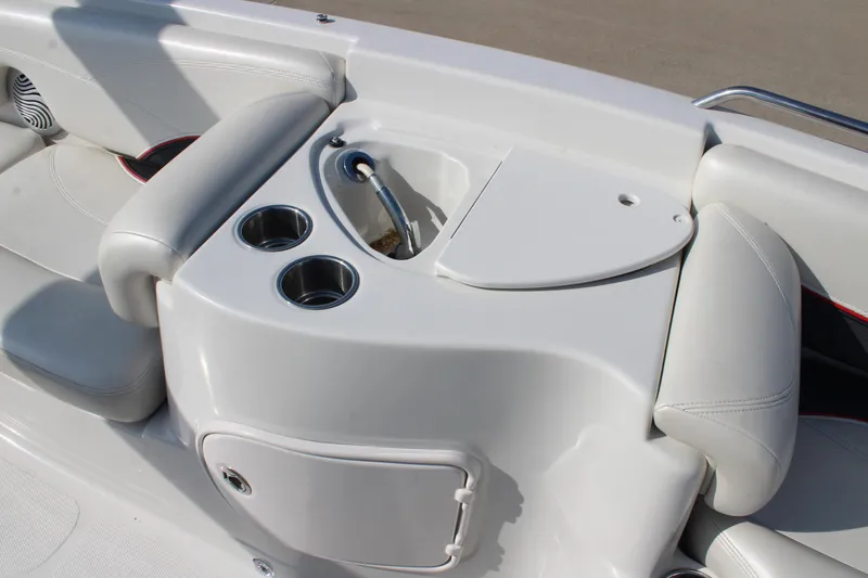 Slide: The Image of 2015 Tahoe 215 I/O boat interior with cup holders and storage compartment. - 22