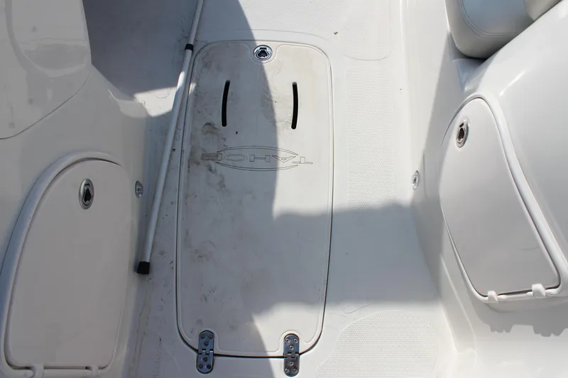 Slide: The Image of Interior view of a 2015 Tahoe 215 I/O boat showing storage compartments. - 23