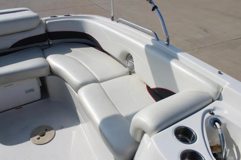 Slide: The Image of 2015 Tahoe 215 I/O boat interior with white seating and cup holders. - 24