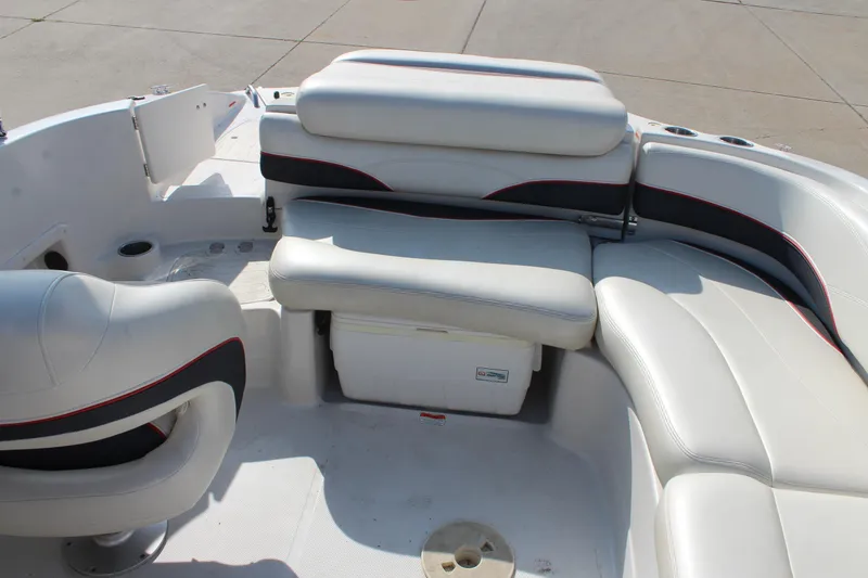 Slide: The Image of 2015 Tahoe 215 I/O boat interior with white seating and storage compartments. - 25