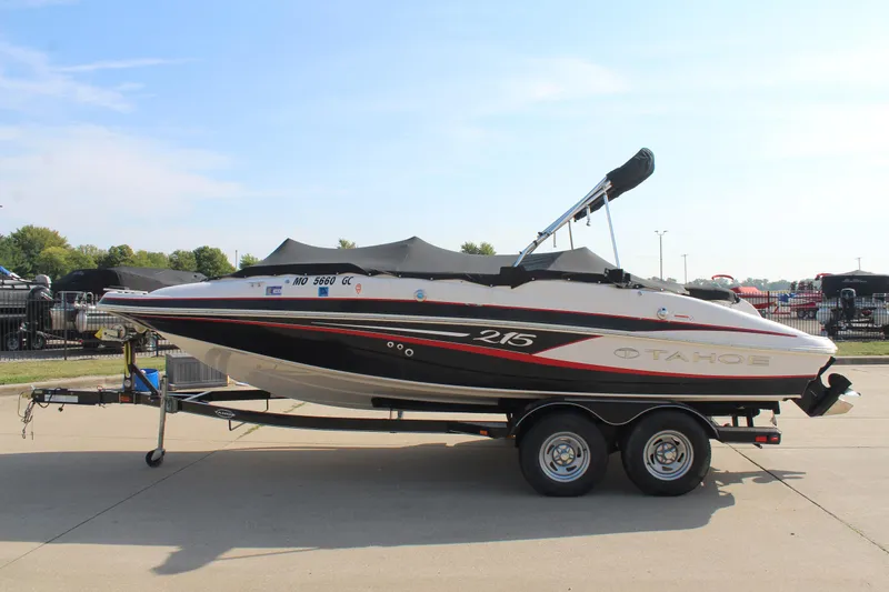 Slide: The Image of 2015 Tahoe 215 I/O boat on trailer, parked outdoors. - 5